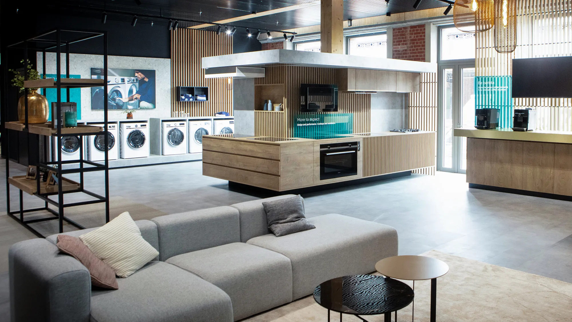 Interior of a premium kitchen and appliance showroom with a lounge area.