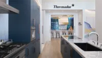 thermador-miami-virtual-showroom-tour-masterpiece-navy-kitchen-view-into-professional-kitchen