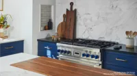 thermador blue knobs on range in blue walnut kitchen