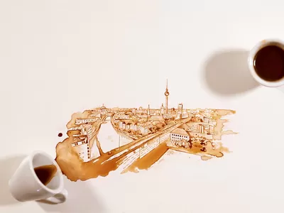 Artistic coffee design in progress, showcasing a creative coffee spill on textured paper.