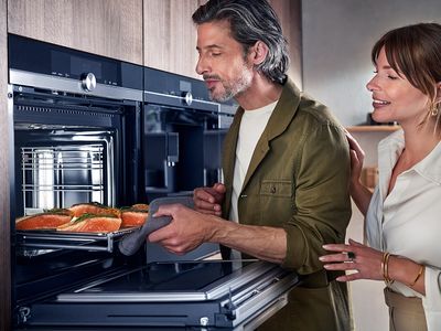 Siemens: mand og kvinde, der tager en færdig ret ud af ovnen