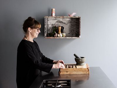 Person sat at table making something