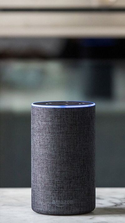 An amazon echo on a table in front of a Siemens oven