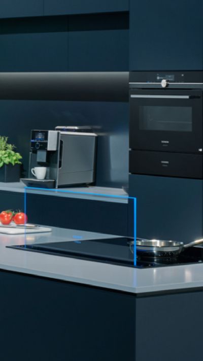 A Siemens kitchen with ovens, glass draft and coffee machine, as well as an amazon echo