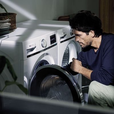 Man loading a washing machine