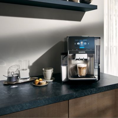 Siemens coffee machine on kitchen surface with coffee cups and sugar bowl