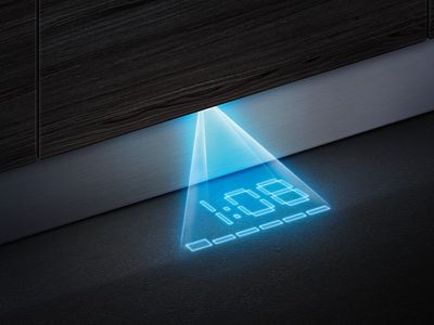 Unterhalb des in der Küche eingebauten Geschirrspülers ist auf dem Fußboden die projizierte Restlaufzeit des Programms zu sehen.