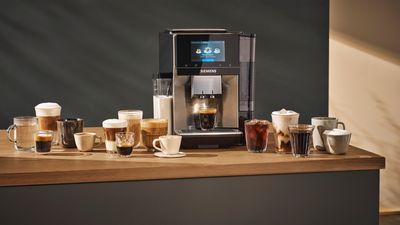 Siemens coffee machine surrounded by coffee cups