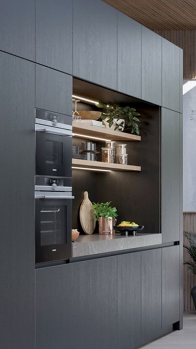 Modern designed kitchen in dark and stone colour showing Siemens studioLine appliances.