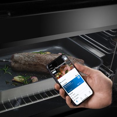 Three pizzas with various toppings arranged on a baking tray, ready for baking. 