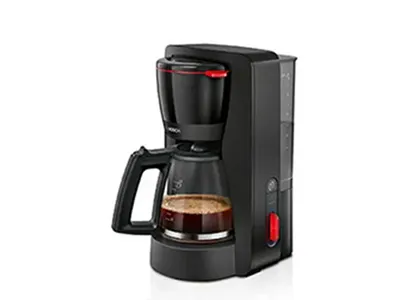 Black automatic drip coffee maker with a glass carafe half full of coffee, on a white background.