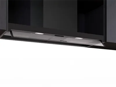 Siemens built-in kitchen extractor hood under a dark cabinet with integrated lighting.