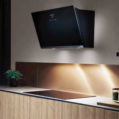 Hood mounted on wall with lights in kitchen