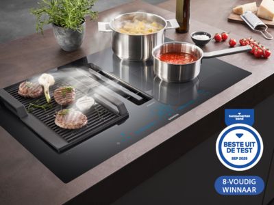 Kookblad met grill en pannen. "Best in Test"-prijzen van april 2025 prominent getoond. 