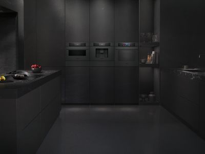 Modern&iacute; elegance v čern&eacute; kuchyni: hladk&eacute; skř&iacute;ňky, vestavn&eacute; spotřebiče a sofistikovan&aacute; tmav&aacute; mramorov&aacute; pracovn&iacute; deska, doplněn&aacute; miskou s v&yacute;razně červen&yacute;mi jablky.