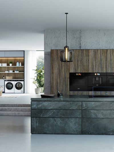 A modern kitchen, with three Siemens built-in ovens.