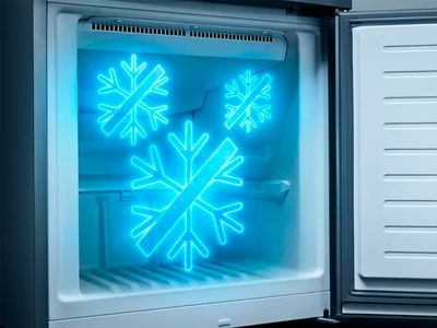 An open freezer compartment with three glowing blue 'no frost' snowflake icons