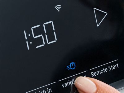 A finger pressing the 'varioSpeed' button on a digital appliance control panel displaying '1:50' and a Wi-Fi icon.