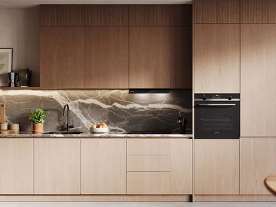 Hood mounted on wall with lights in kitchen