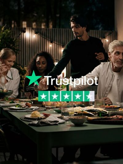 People sat around a dinner table with lots of food and a Trustpilot logo overlay