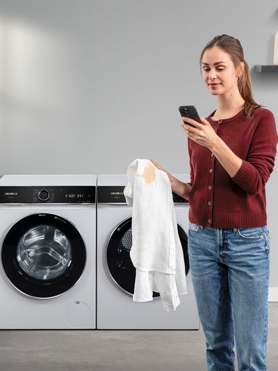 Person sat on sofa using mobile