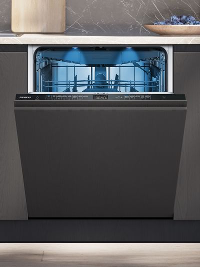 Siemens dishwasher with door slightly open showing interior