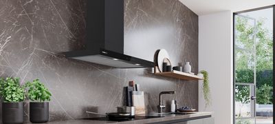 Campana de cocina Siemens elegante montada con estilo, complementada por arte moderno y pared de m&aacute;rmol