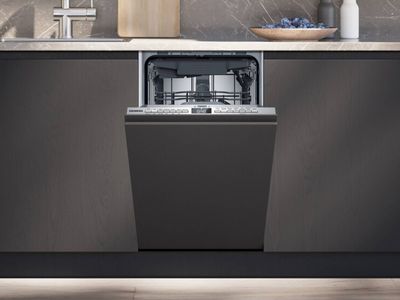 Open small dishwasher in minimal kitchen