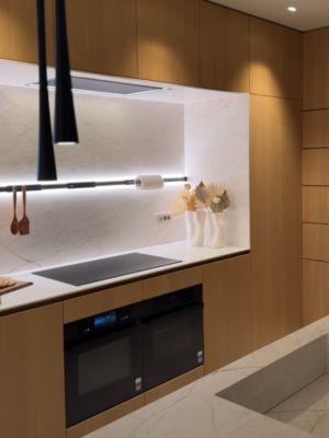 Zona de cocinado equipada con placa flexinducci&oacute;n total, horno con microondas y horno de vapor Siemens, en acabado negro mate.