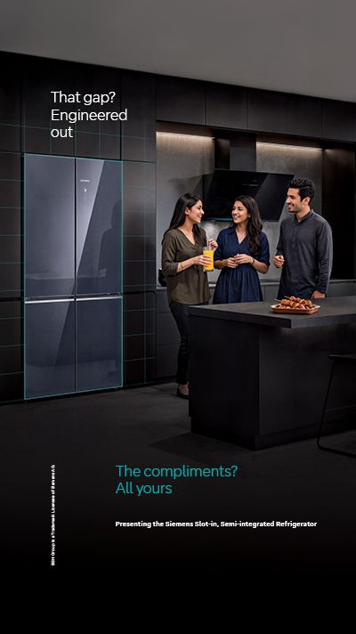 Three people in a modern kitchen with a Siemens refrigerator, text reads "That gap? Engineered out" and "The compliments? All yours. Presenting the Siemens Slot-In, Semi-Integrated Refrigerator".