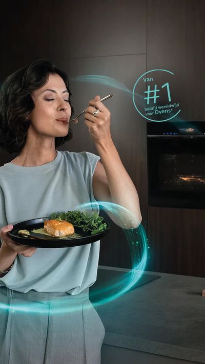 A woman is standing in front of a built-in iQ700 oven. She is holding a plate with a salmon dish and a fork in her hand.
