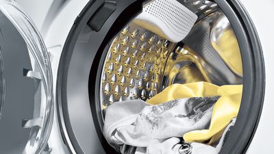 Siemens-kodinkoneiden asiakaspalvelu, avoin pyykinpesukone, jossa on sisällä likaisia vaatteita