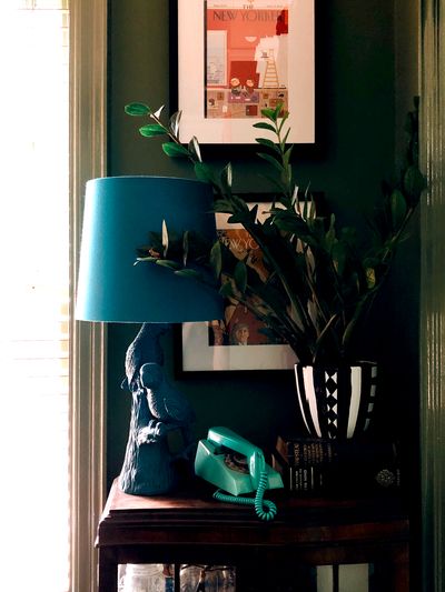 Retro blue lamp and phone, on small table