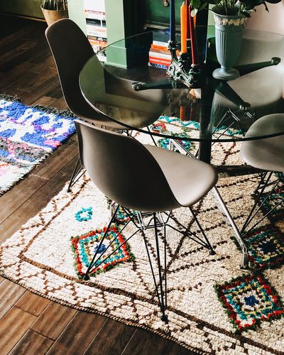 Modern table chairs in a maximalist room