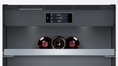 Close up of wine cooler interioir with self temperatures on digital display.