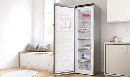 A modern refrigerator with a glass front open, showcasing organized shelves filled with food items, set in a bright kitchen.