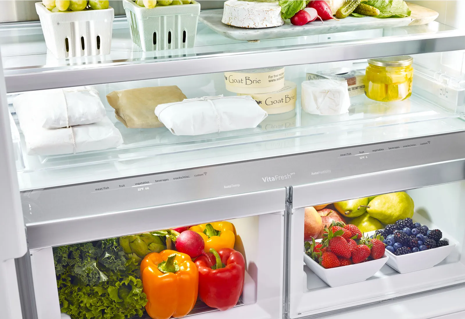 Bosch Refrigerator interior with various fresh produce, dairy products, and other food items neatly organized.