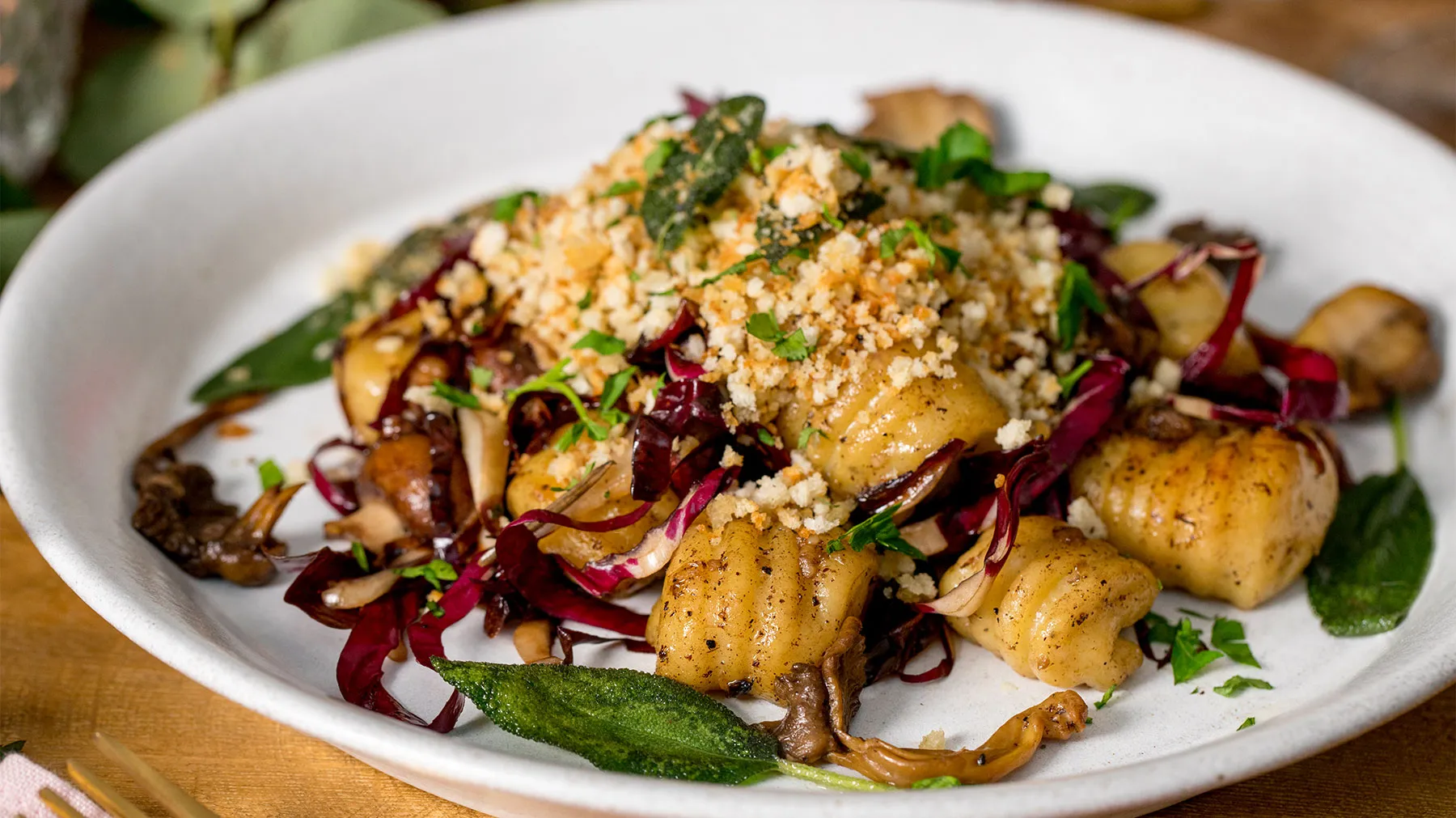 Plate of roasted vegetables, couscous, and herbs - a colorful and appetizing vegetarian dish.