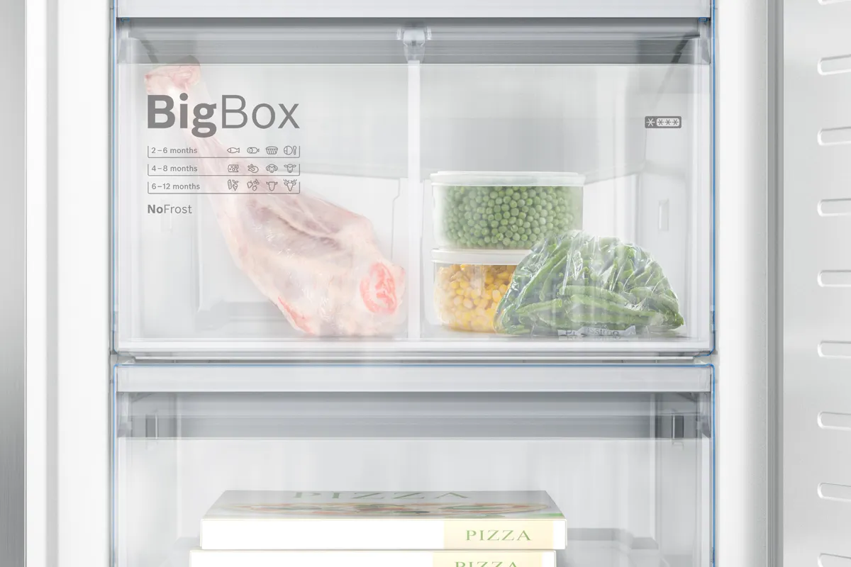Close up of a Bosch freezer full of meat and vegetables. BigBox shows large freezer capacity.