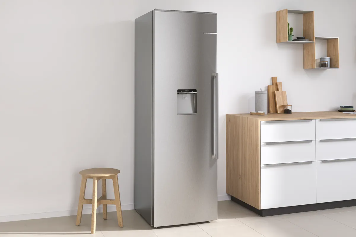 A 60-cm built-in Bosch fridge with open door to show food and drinks inside.