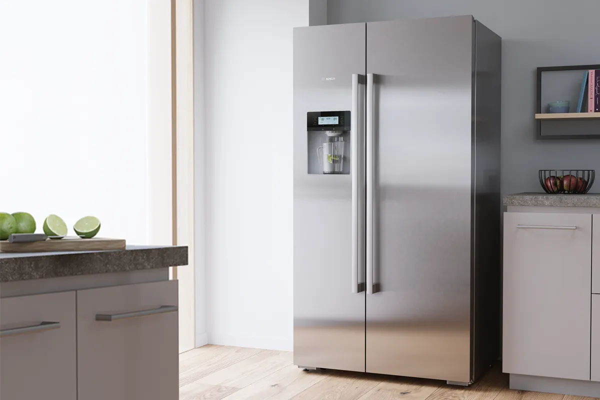A 60-cm built-in Bosch fridge with open door to show food and drinks inside.