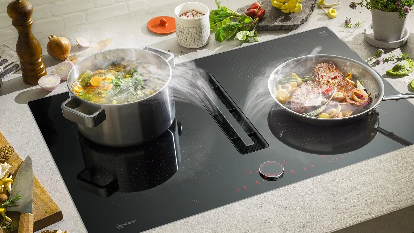 Cooking appliances, pots, vegetables, herbs, and cooking utensils on a kitchen counter.