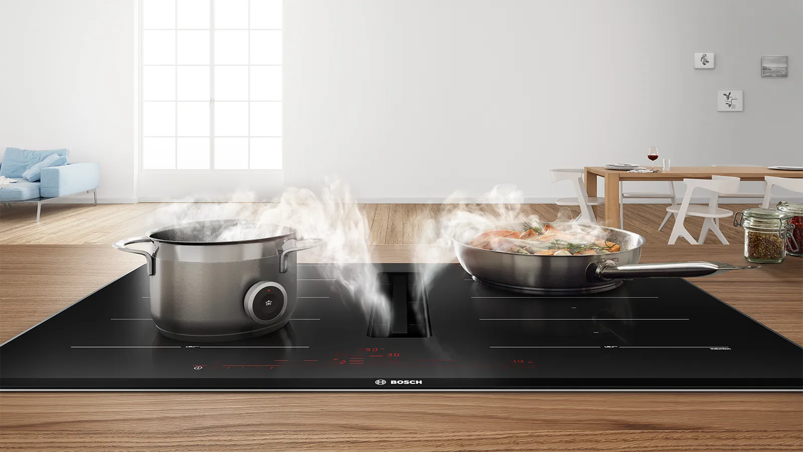 Cucina moderna con piano cottura a induzione, pentole e vapore che fuoriesce, tavolo in legno e soggiorno sullo sfondo.