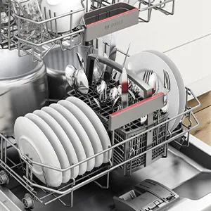 Opened Bosch Dishwasher filled with cutlery and dishes