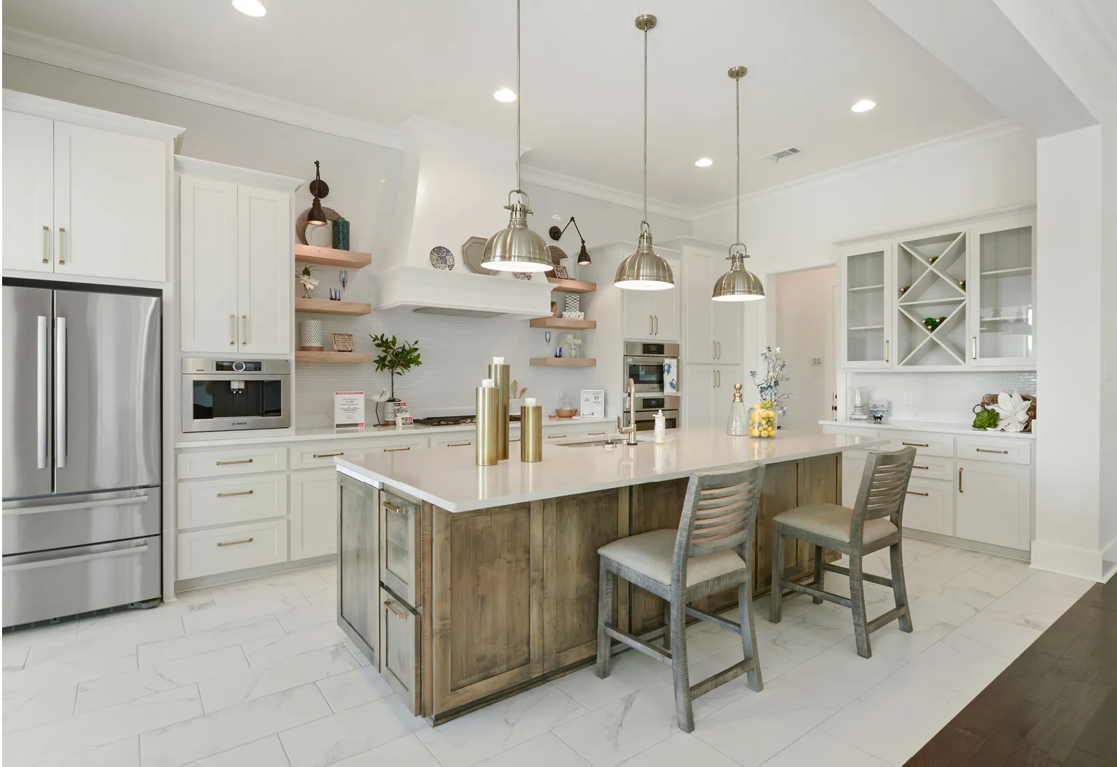 Modern kitchen with white cabinets, island with wooden accents, and Bosch stainless steel appliances.