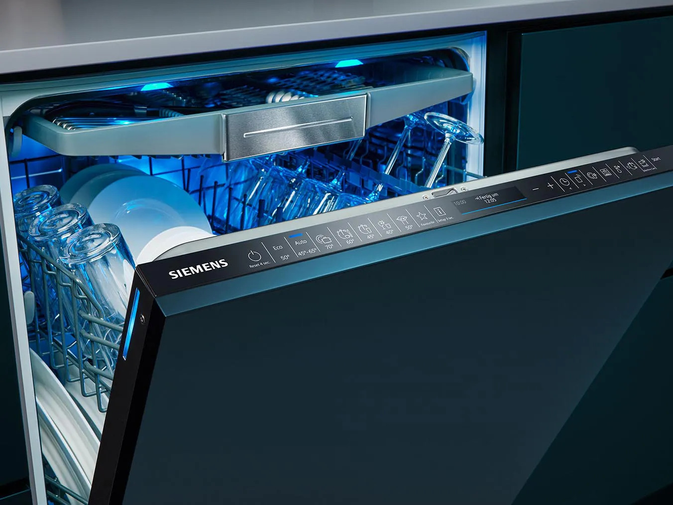 Dishwasher interior with clean dishes, racks, and control panel.