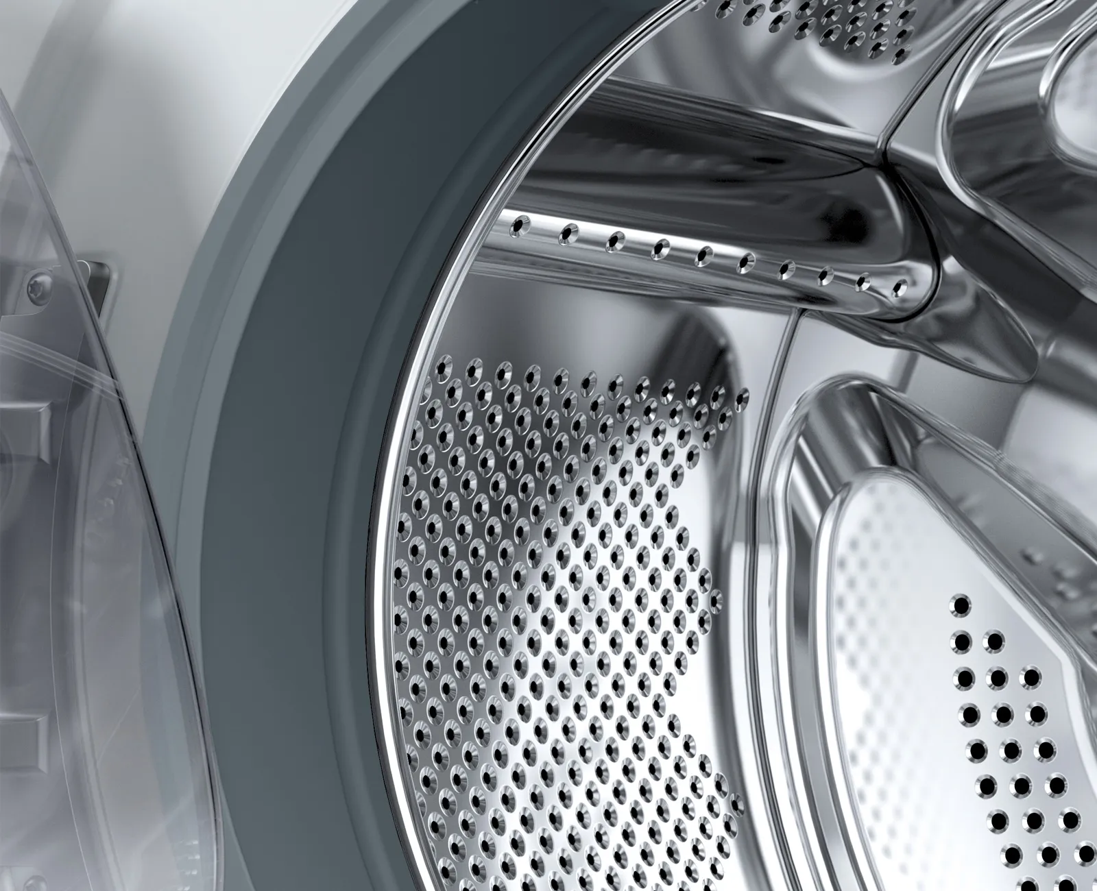 Close-up of a washing machine drum with perforated metal surface.