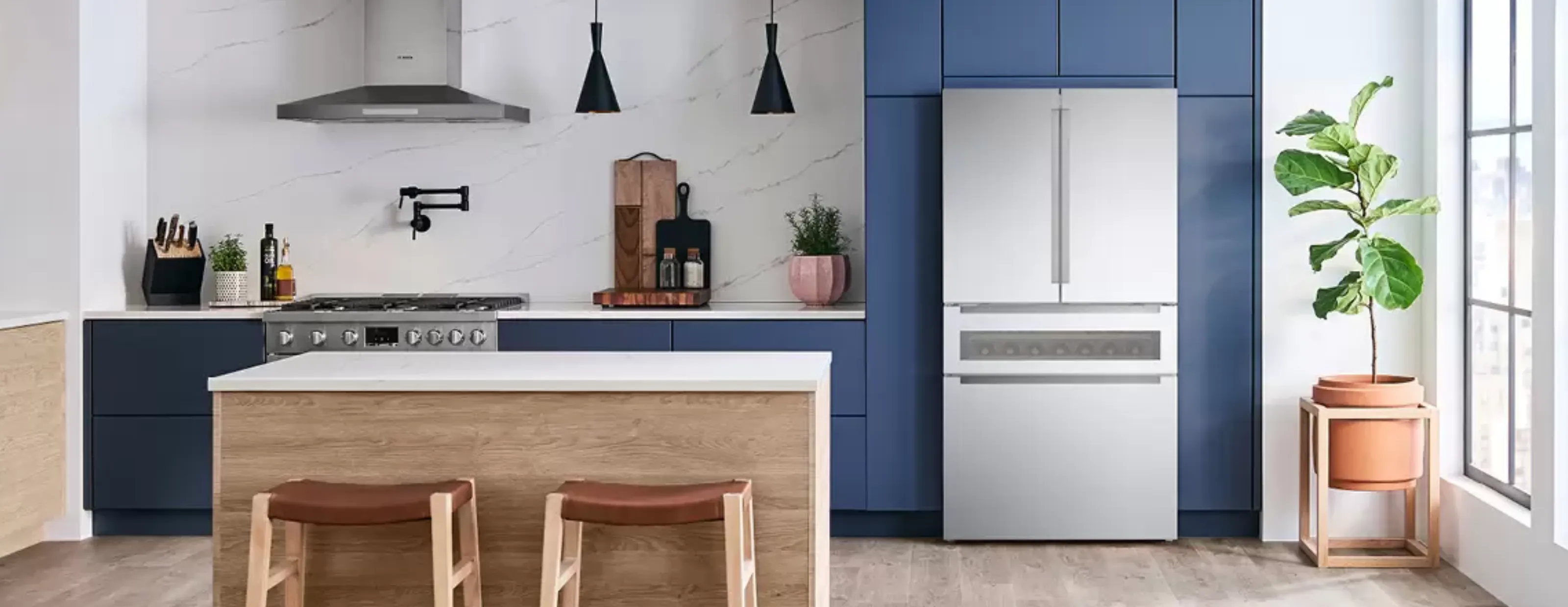 Bosch Fridge with Refreshment Center in a kitchen with navy blue cabinets