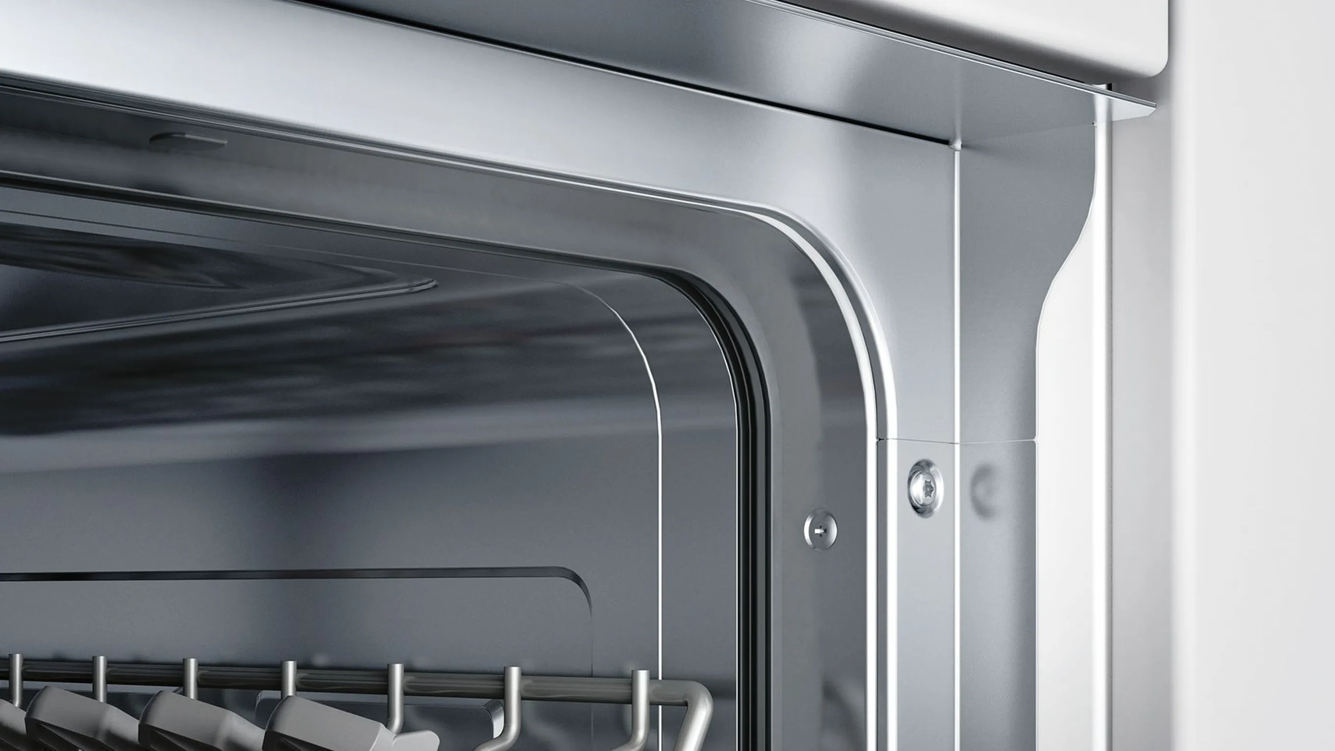 Close-up of a modern stainless steel oven door with a blurred interior view.
