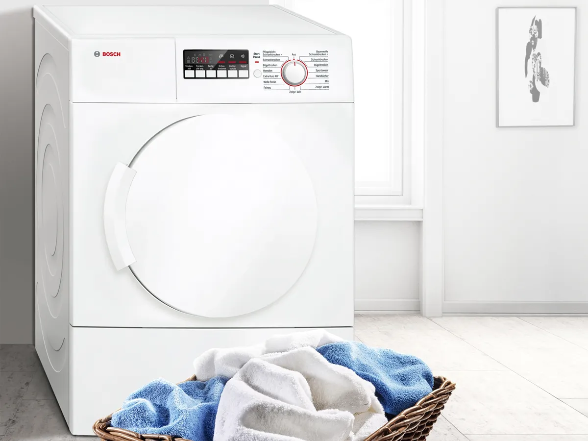 Tumble dryer in white utility room